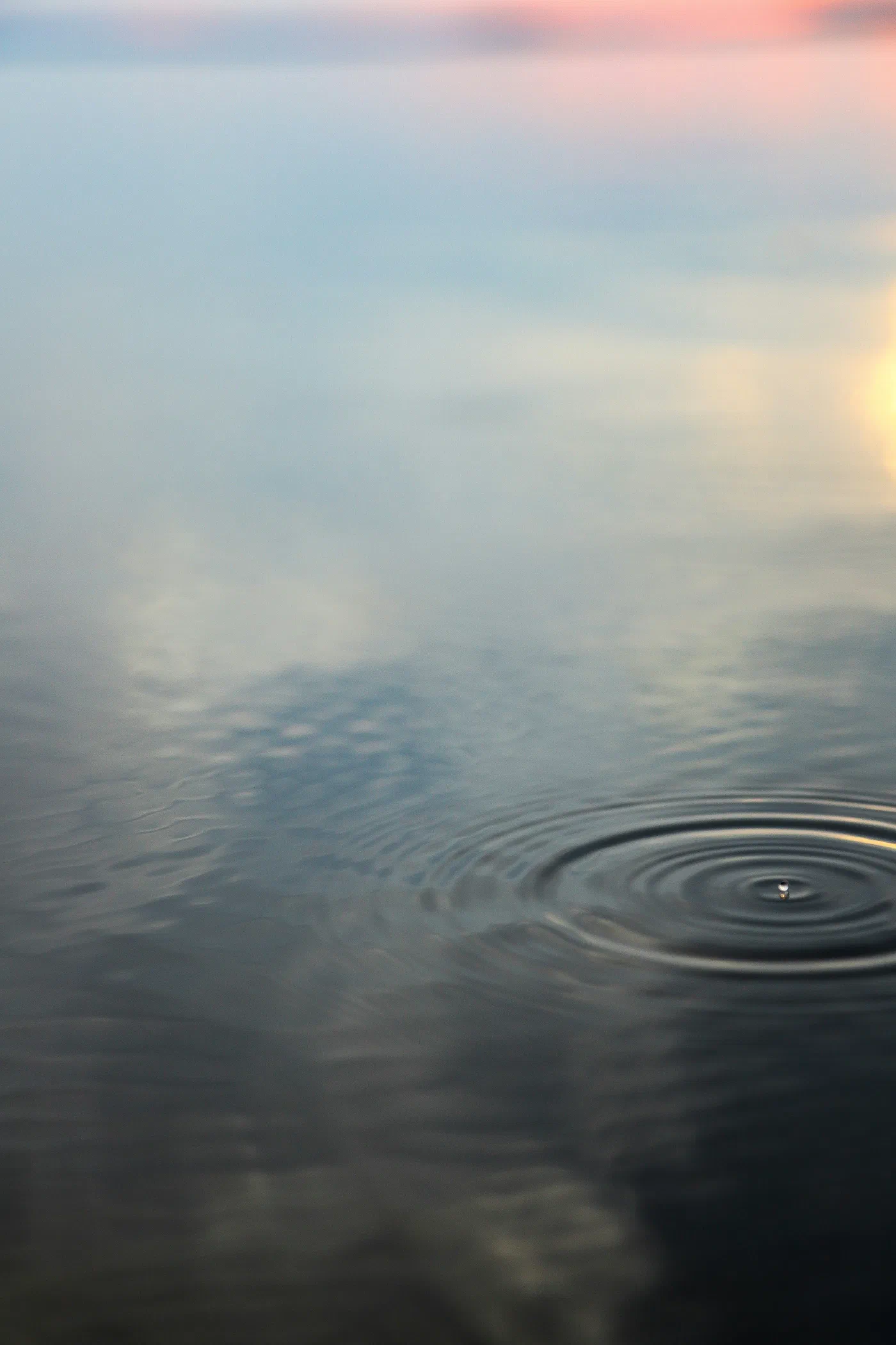 Water drops rippling across the surface of water