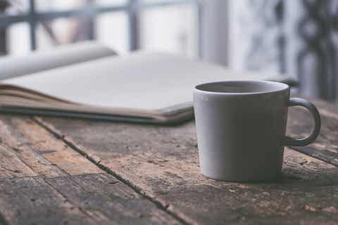A white ceramic mug on a brown table